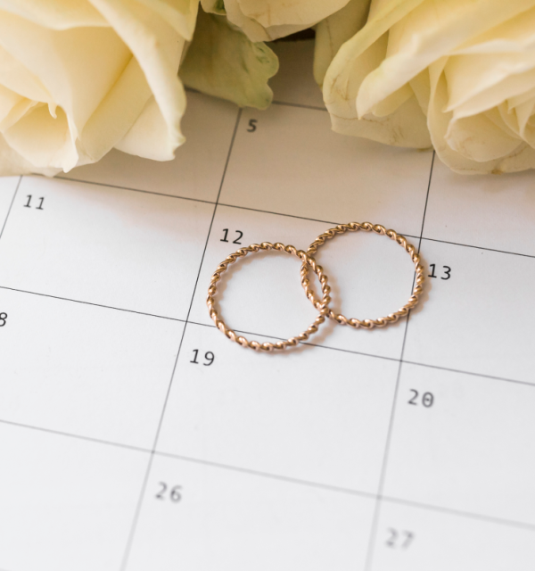 Wedding rings on a calendar representing legal notice period for civil weddings in Ireland